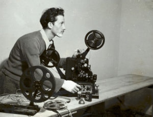 Black and white photograph of man with projector