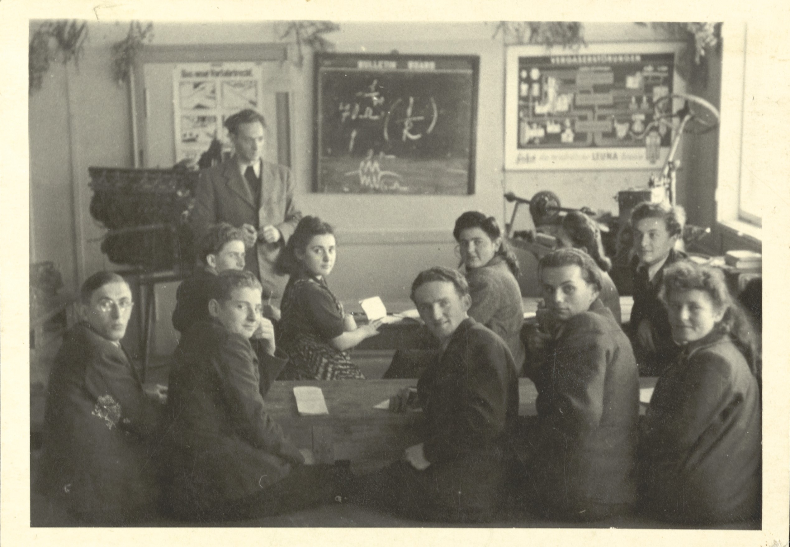 Black and white photograph of students taking a class postwar in a DP camp