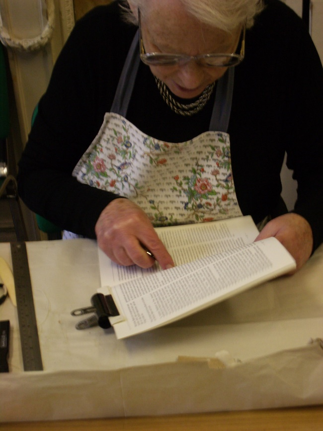 Volunteers undertaking conservation work on valuable printed materials.